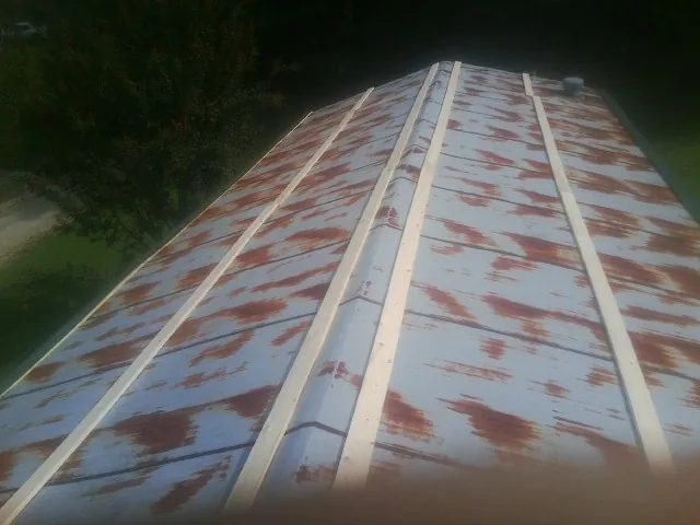 Rusted metal roof panels with new wood purlins before replacement — Storm Damage Roof Repair in Alberton by Roofing Brothers